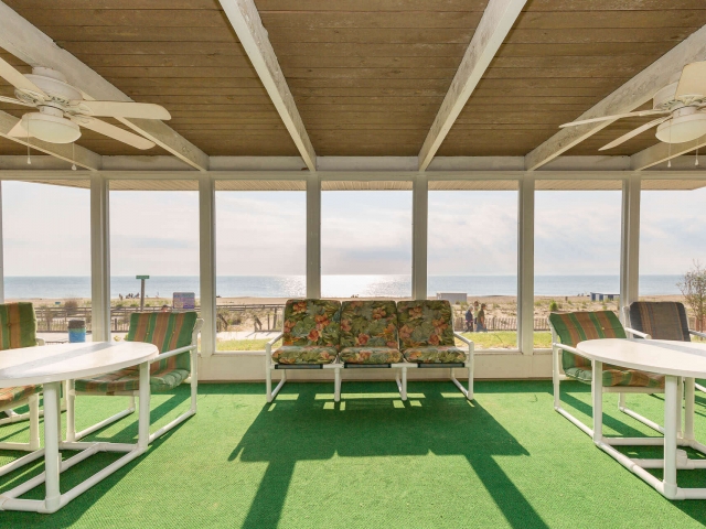 The screened front porch facing the beach and ocean